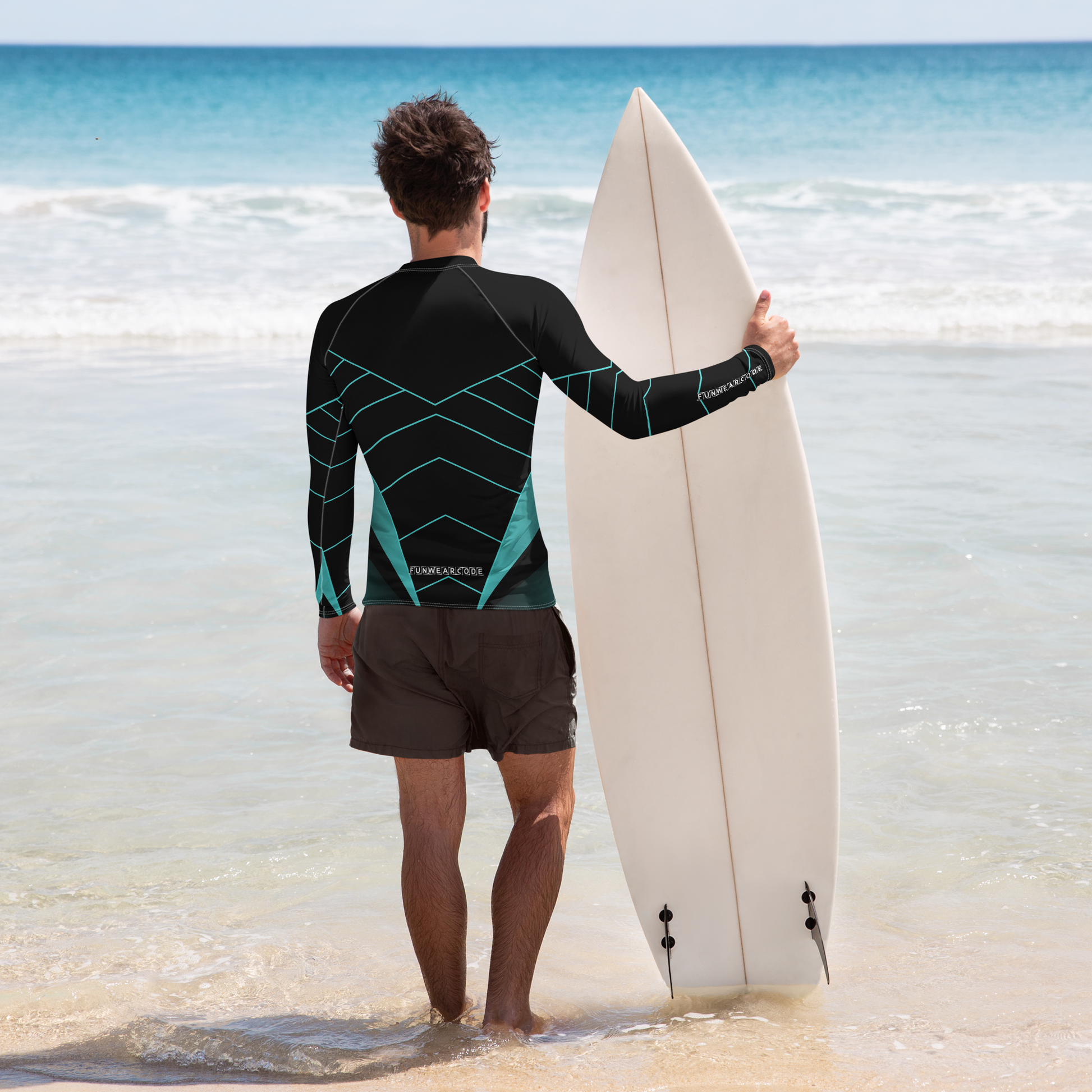 Person in a  "Fun Wear Code" branded wetsuit holding a surfboard on a beach