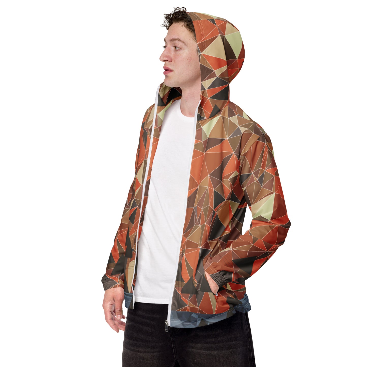 Person wearing a multicolor geometric patterned windbreaker jacket on a white background