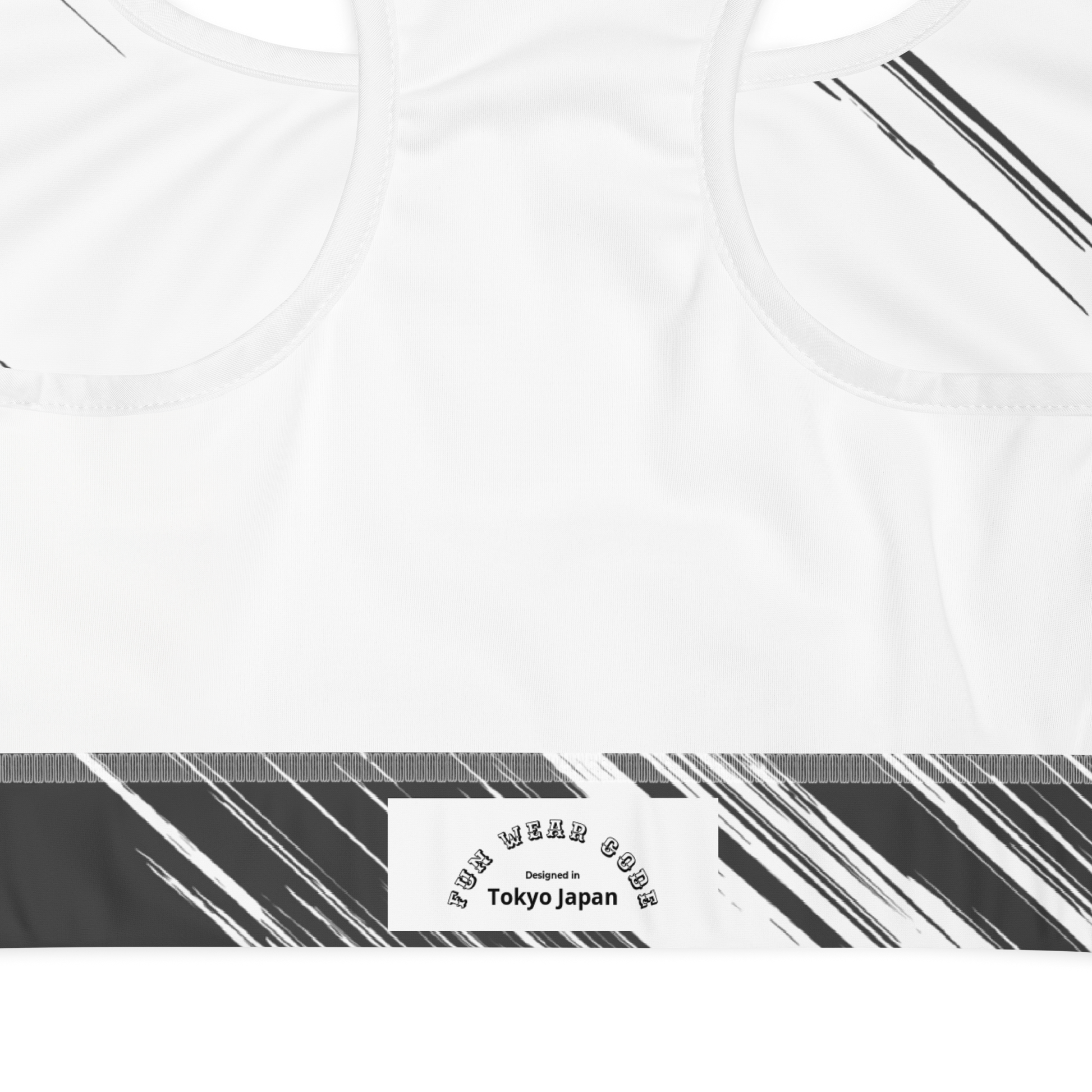 White sports bra with black and gray striped design and with a brand logo 'Funwearcode' 'Designed in Tokyo Japan' label.