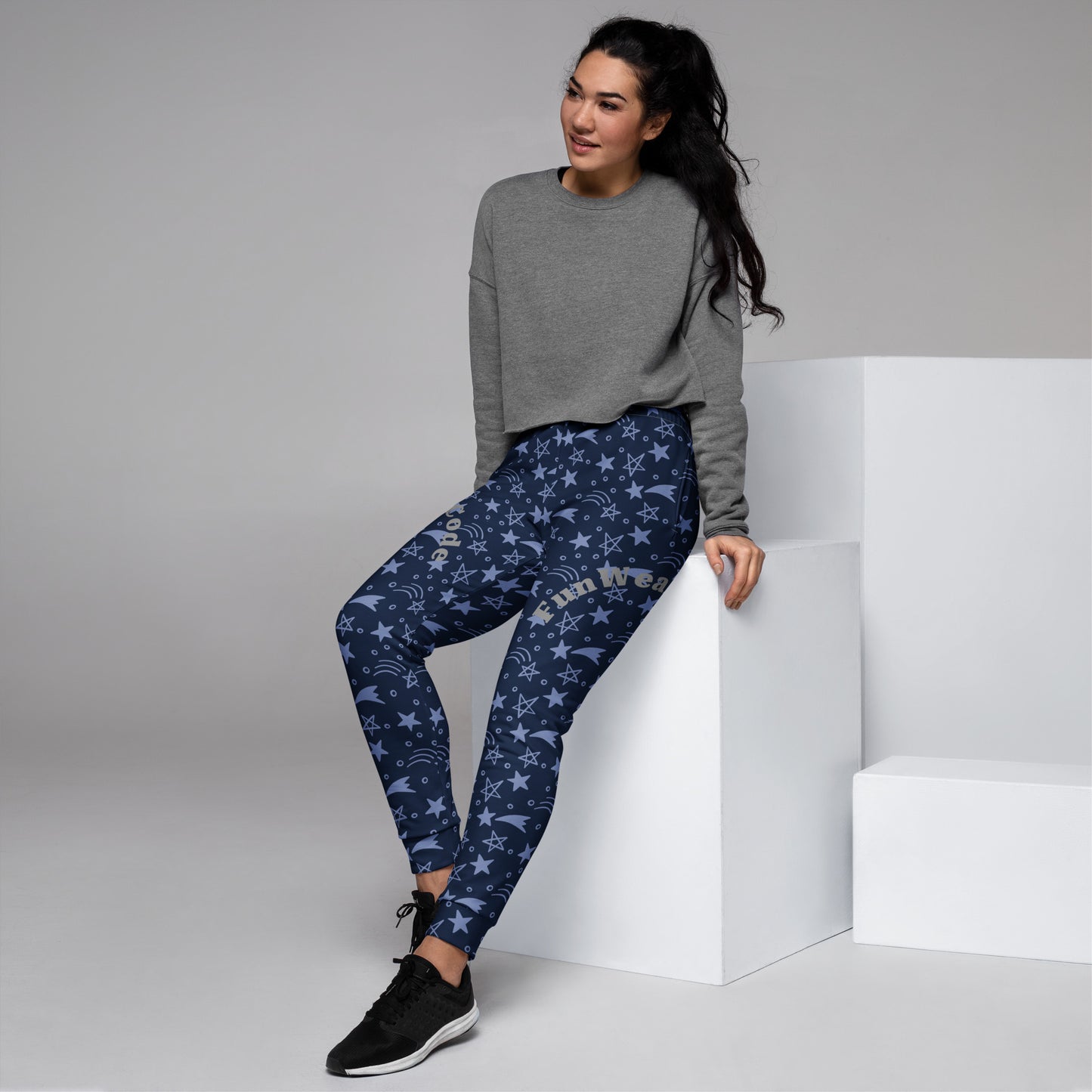 Woman wearing a gray sweatshirt and blue star-patterned joggers with 'Fun Wear Code' text logo on a white background