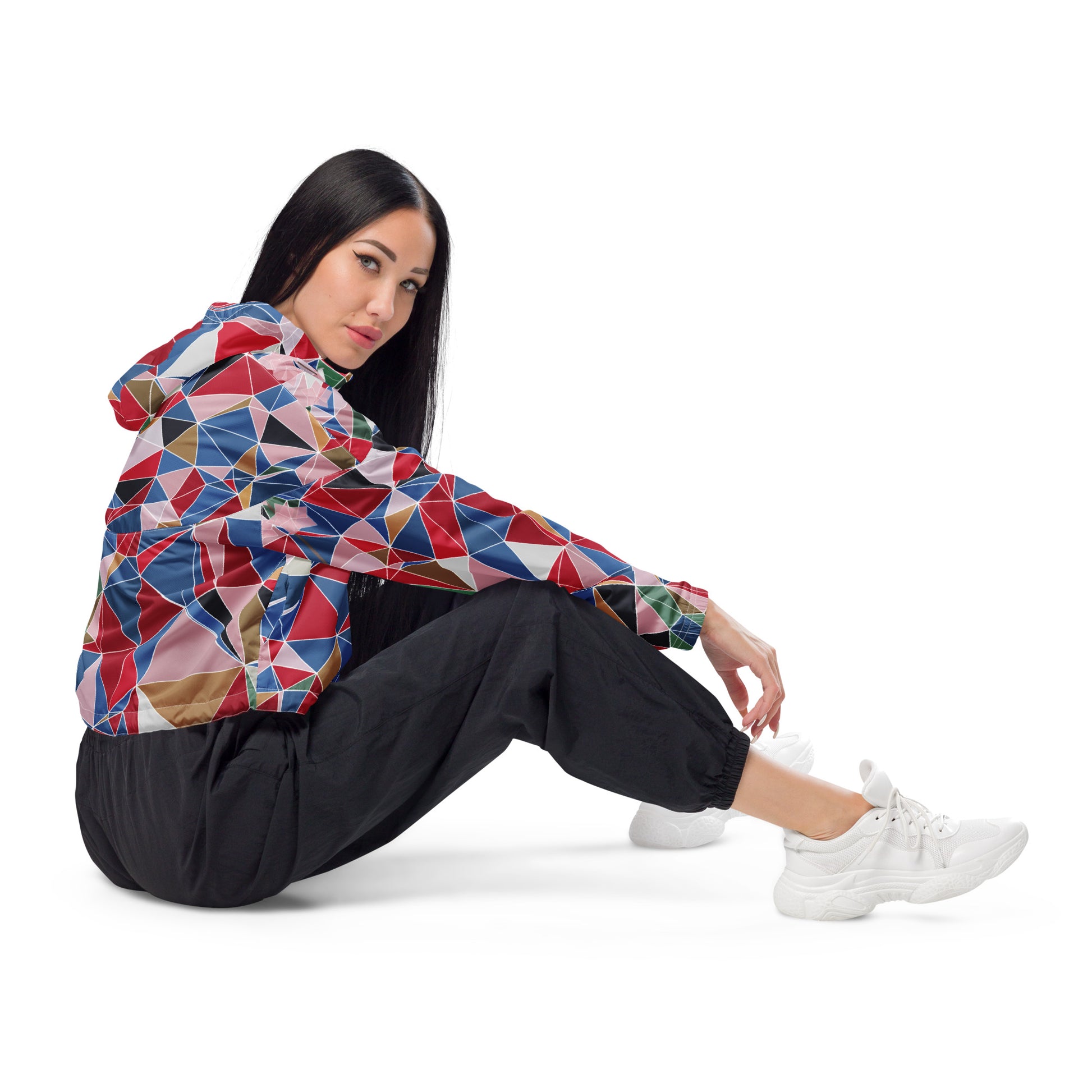 Person wearing a colorful geometric-patterned jacket with spring cherry blossom graphic on a white background