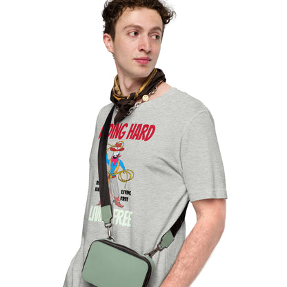 Man wearing a gray t-shirt with a cowboy graphic design and holding a green bag on a white background