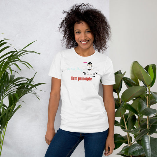 Woman wearing a white t-shirt with a judo graphic design and text, standing between two plants against a light background